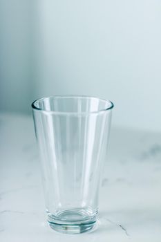 Glassware, washing and purity concept - Clean empty glass on marble table