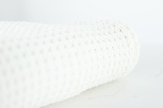 Knitwear, fabric textures and handmade items concept - Warm knitted clothes, soft and white