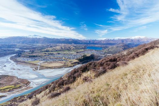 The view over Queenstown and Lake Hayes from the Remarkables on a sunny spring day in New Zealand