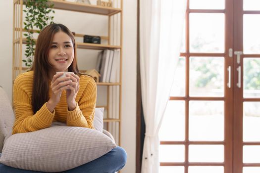 Portrait of an Asian businesswoman or business owner taking a coffee break while working in the office.