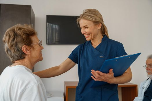 Doctor supporting a sick patient before medical procedures in a hospital room. High quality photo