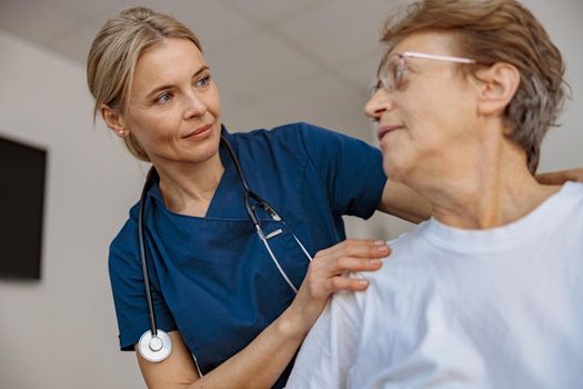 Doctor supporting a sick patient before medical procedures in a hospital room. High quality photo