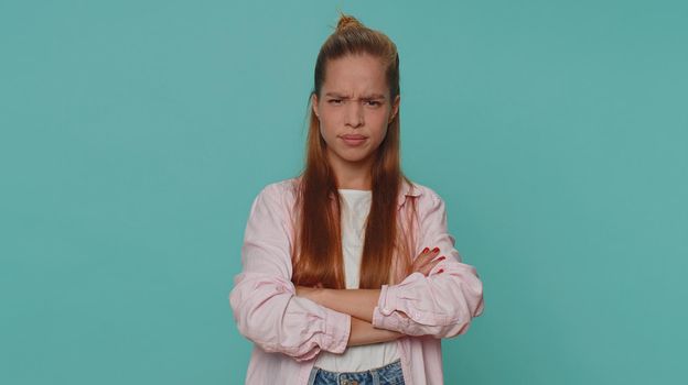 Dissatisfied pretty teenager girl asking reason of failure, expressing disbelief irritation, feeling bored, disappointed in result, bad news. Young child kid isolated alone on blue studio background