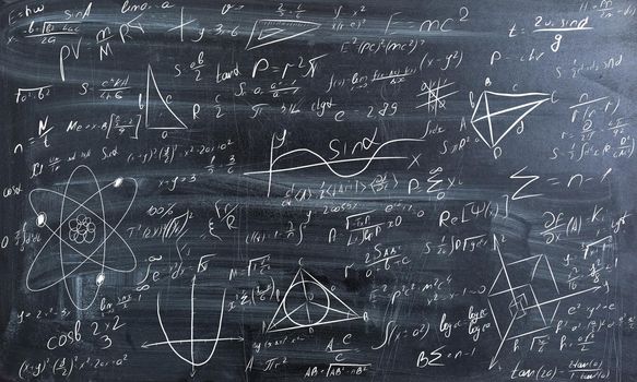 Blackboard inscribed with scientific formulas and calculations in physics and mathematics. . High quality photo