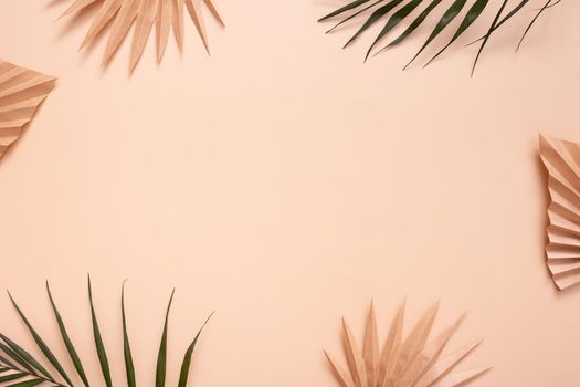 Decorative tropical palm dry leaves on beige background. Copy space.