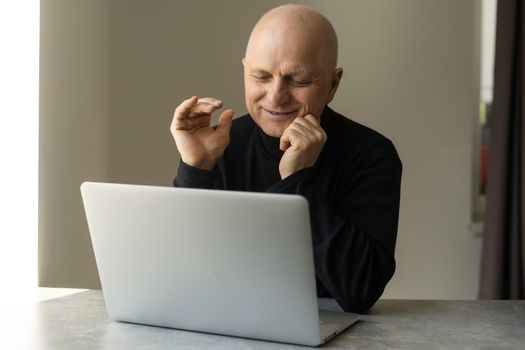 Close up of modern elderly man sit at home having online consultation with doctor on computer, sick senior male talk on video call consulting with female nurse using laptop, healthcare concept