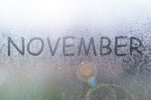 Autumn rain, the inscription on the sweaty glass - November.