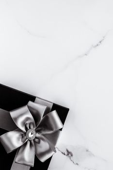 Present for him, shop sale promotion and anniversary celebration concept - Luxury holiday gifts with silver silk ribbon and bow on marble background