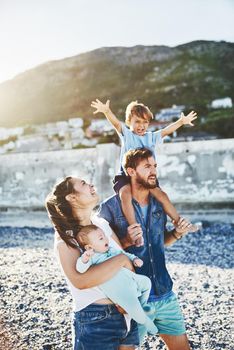 Family fun time at the beach. a young family spending quality time at the beach