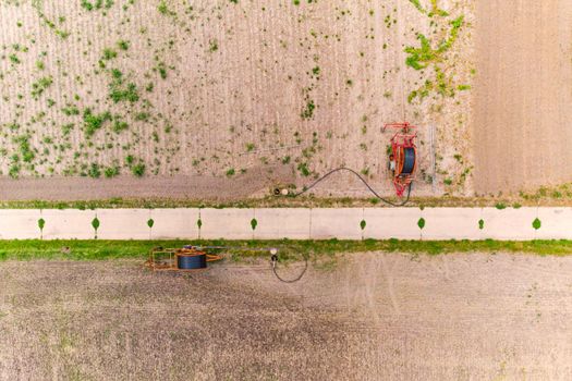 Aerial view of irrigation truck for sprinkling agricultural field, Germany in drought