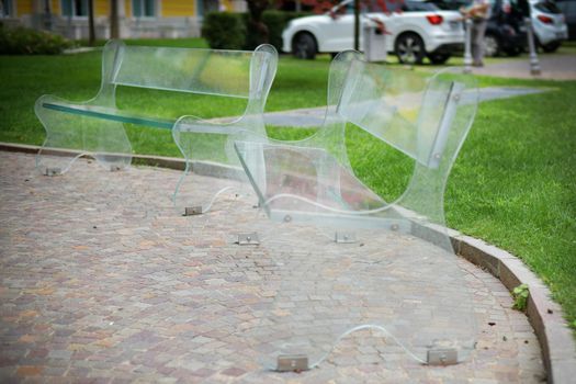 Eco-friendly transparent benches in a leisure park