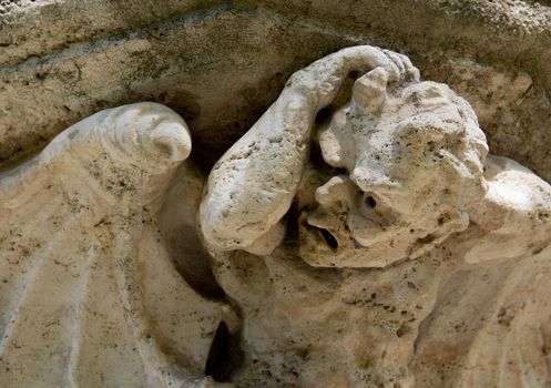 Eroded building stone statue close-up of an angel. High quality photo