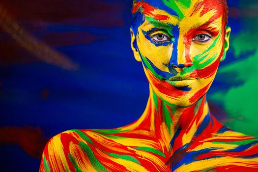 Portrait of the bright beautiful emotional woman with art make-up