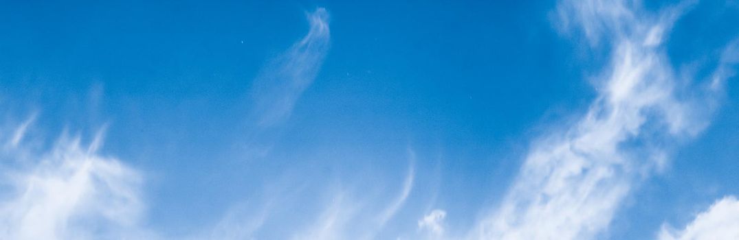 Nature backdrop, solar energy and spiritual concept - Blue sky background, white clouds and bright sunlight