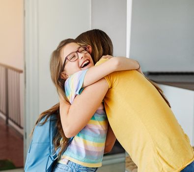 Portriat of a young teen school girl with backpack welcomed by her mother after coming back from school at home