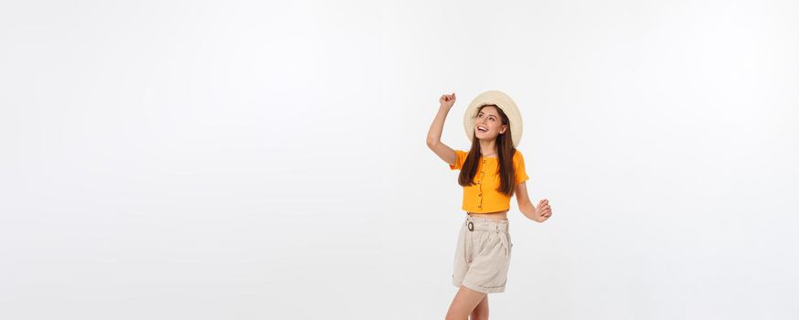 Cool hipster portrait of young stylish teen girl showing her hands up, positive mood and emotions,travel alone. Isolated over grey background.