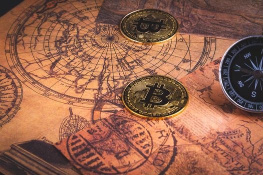 Compass and bitcoin. Travel and cryptocurrencies. Buying tickets with bitcoins. Alternative currency and travel. Coin and compass on the map.