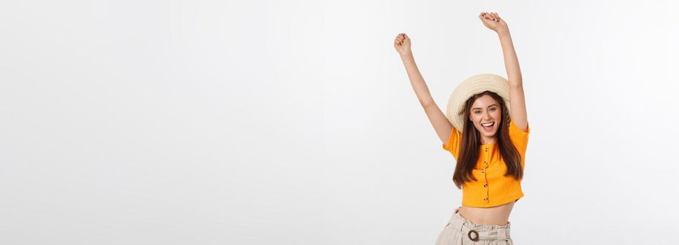 Cool hipster portrait of young stylish teen girl showing her hands up, positive mood and emotions,travel alone. Isolated over grey background.