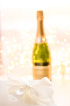 Romantic celebration, lifestyle and luxury present concept - The bottle of champagne and holiday gift box