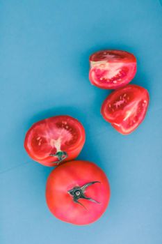 Plant based diet, vegetarian recipe and farm garden concept - Fresh ripe red tomatoes on blue background, organic vegetable food