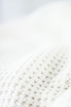 Knitwear, fabric textures and handmade items concept - Warm knitted clothes, soft and white