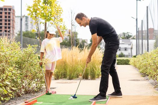 Closeup of player play mini golf with ball.