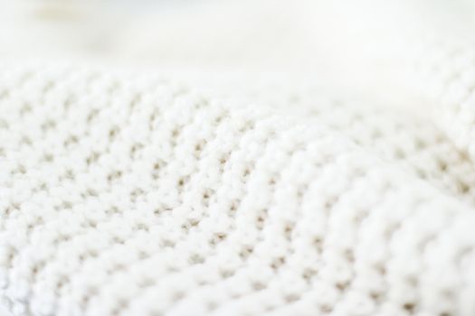 Knitwear, fabric textures and handmade items concept - Warm knitted clothes, soft and white