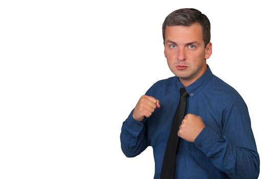 Man in blue shirt and tie with angry facial expression, hands clenched into fists and two hands raised up, isolated on white background.