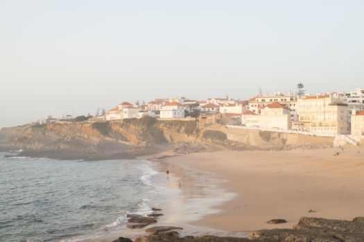 Praia das Macas Apple Beach in Colares, Portugal, on a stormy day before sunset Small city on ocean shore