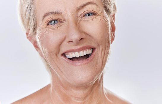 Dentist, veneers or dentures in senior woman mouth or teeth looking happy with her oral hygiene or dental cleaning cosmetic service. Mature model with smile on face for dentistry, health and wellness.