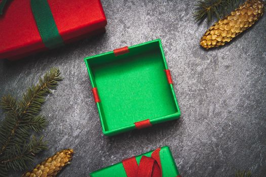 Gift box on a black background. New Year's gift top view. Red and green boxes. Surprise on the table.