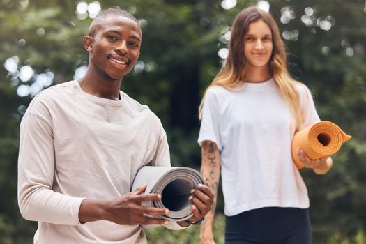 Happy, nature and yoga of a couple together on a journey for healthy mind, spirit and body in the outdoors. Portrait of an interracial man and woman in fitness ready for a natural stretching workout