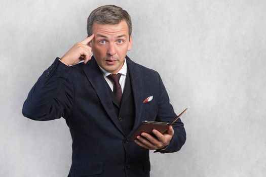 Portrait of a crazy man with a gadget in his hand...Getting strange unusual news on the Internet. Man on a white isolated background.