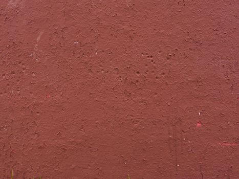 Old wall covered with red paint. Art brown concrete stone texture for background.