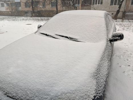 Closeup image of frosen car wipes lying on windshield.