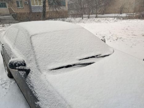Closeup image of frosen car wipes lying on windshield.
