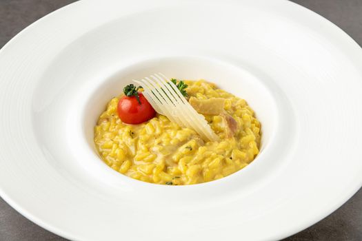 Parmesan cheese risotto on a white porcelain plate