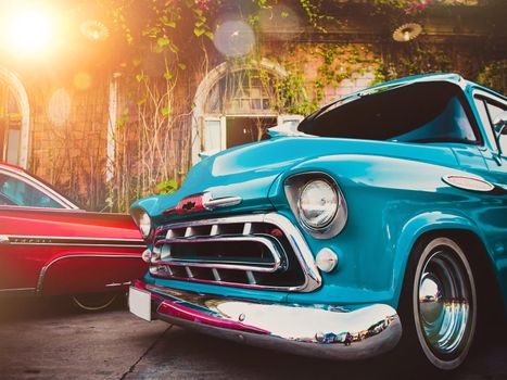 Blue vintage classic car in a colorful street of old town. Travel and tourism concept.