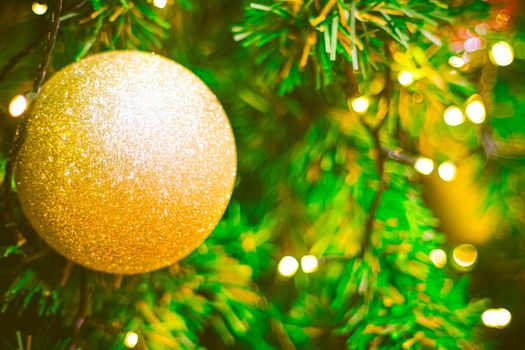 Christmas ball decoration on yellow background. Colorful blur bokeh background. christmas background