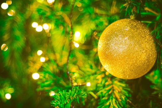 Christmas ball decoration on yellow background. Colorful blur bokeh background. christmas background