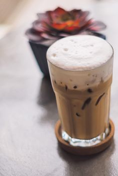 iced latte coffee in a  tall glass. cold summer drink background