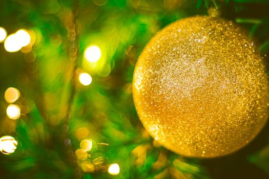 Christmas ball decoration on yellow background. Colorful blur bokeh background. christmas background