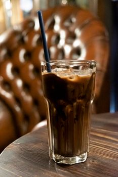iced latte cocoa chocolate in a  tall glass. cold summer drink background