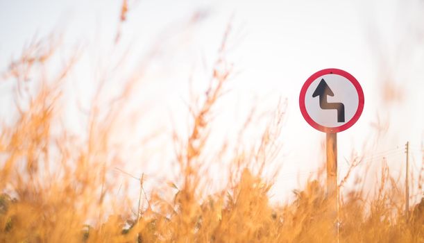 Traffic street  transportation sign over dried grass nature meadow field