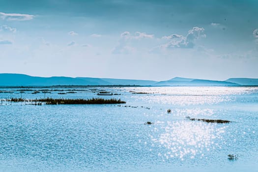 Mountain lake with perfect of blue ocean beautiful landscape with glitter light  reflected in water. Nature lake landscape