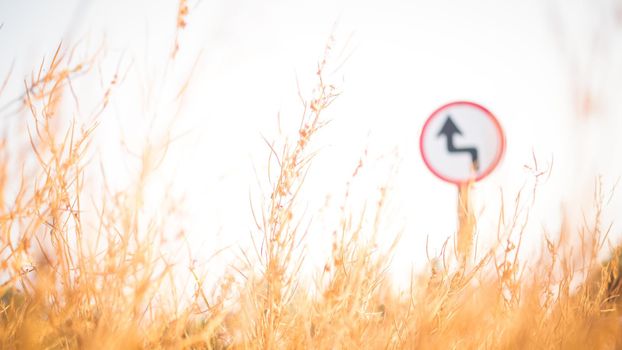 Traffic street  transportation sign over dried grass nature meadow field