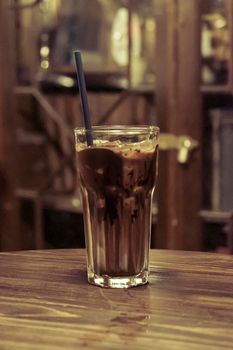 iced latte cocoa chocolate in a  tall glass. cold summer drink background