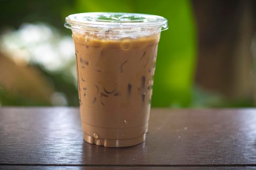 iced latte coffee in a  tall glass. cold summer drink background