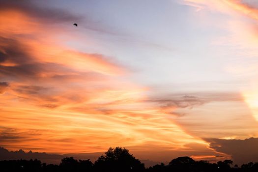 Beautiful sunset sky above clouds.  orange sunset sky. Beautiful sky. Dramatic red yellow pastel color at sunset.