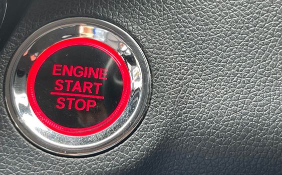 car engine start stop button on dark leather background. copy space Engine Start Button on my car